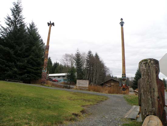 Totem poles around the sign.